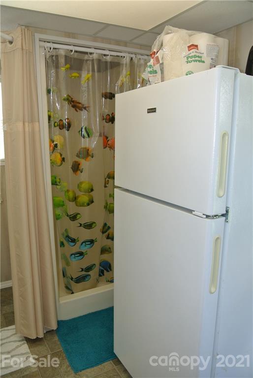 475 West V Thompson Road Rutherfordton, NC 28139 - Photo 42 of 46 a white refrigerator freezer and a table in a kitchen