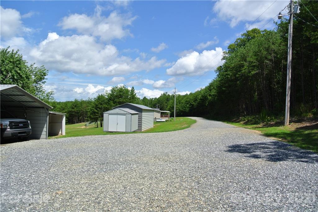 475 West V Thompson Road Rutherfordton, NC 28139 - Photo 44 of 46 a view of a house with a yard and large trees