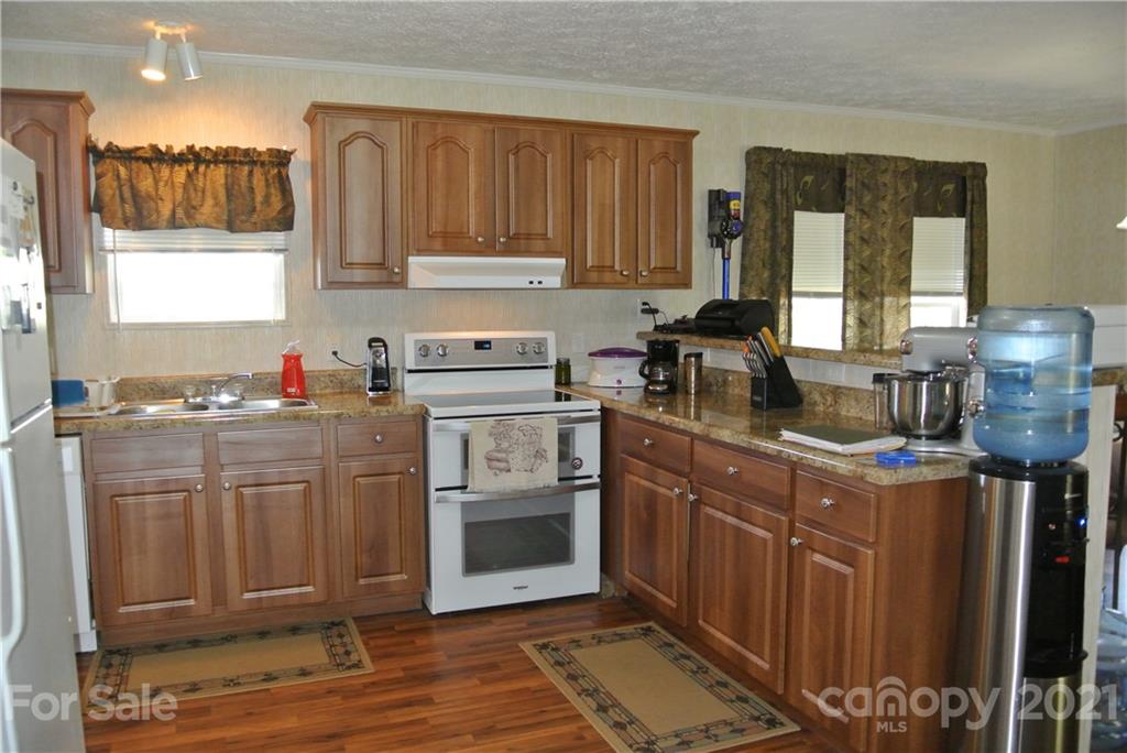 475 West V Thompson Road Rutherfordton, NC 28139 - Photo 10 of 46 a kitchen with stainless steel appliances granite countertop a stove a sink dishwasher and a microwave oven with cabinets