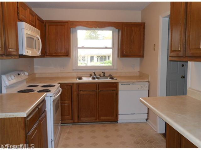 Kitchen. The kitchen is efficiently arranged and has a window view of the neighborhood.