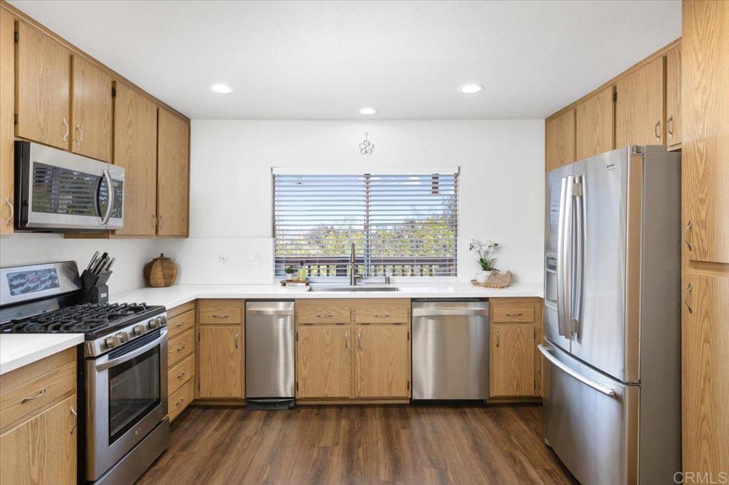 365 Windyridge Glen Escondido, CA 92026 - Photo 5 of 24 a kitchen with a sink a refrigerator a microwave and cabinets