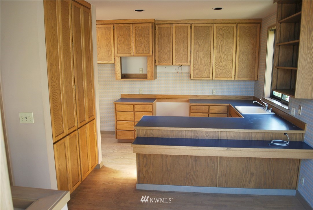 2021 1st Avenue, Unit 55 Seattle, WA 98121 - Photo 13 of 20 a room with wooden floor and furniture