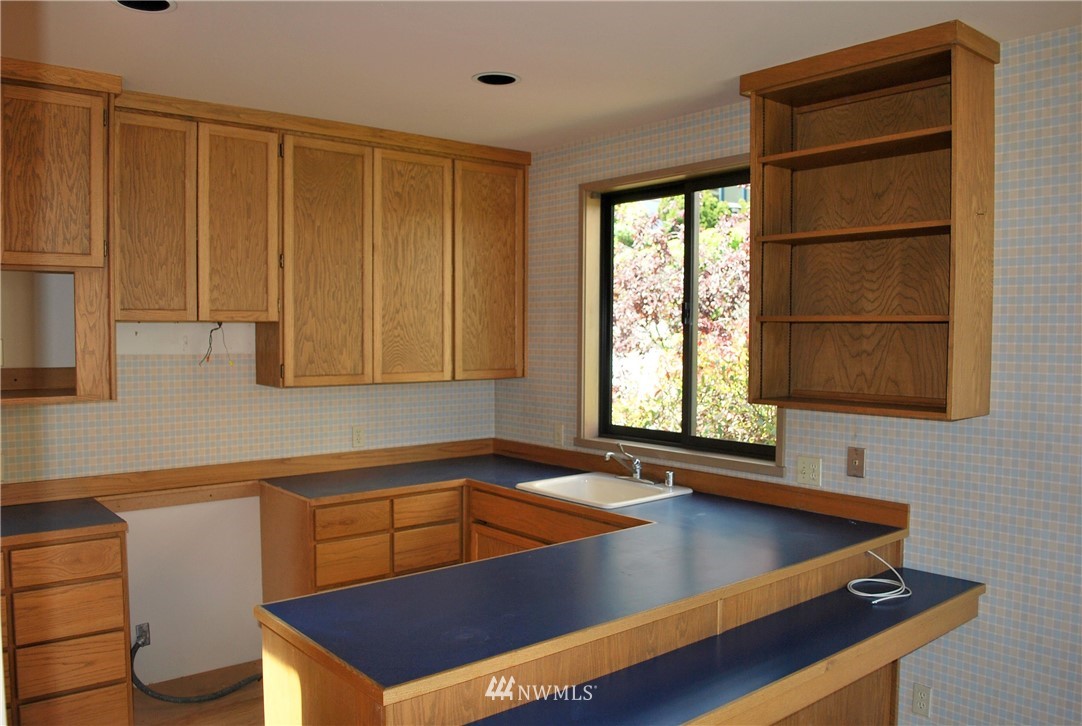2021 1st Avenue, Unit 55 Seattle, WA 98121 - Photo 14 of 20 a view of a kitchen with kitchen island a sink and a window