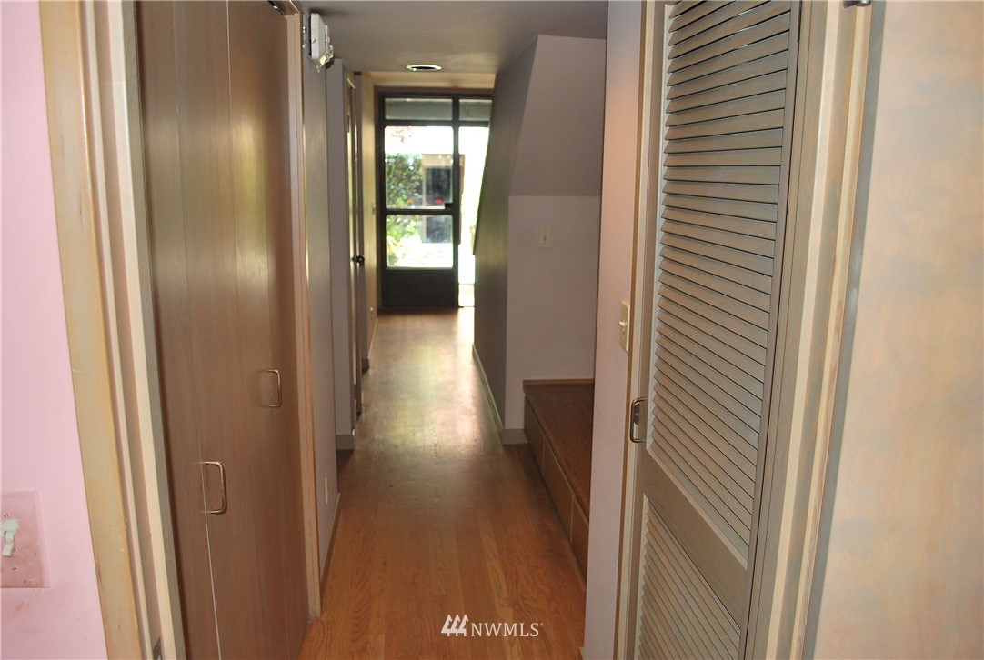 2021 1st Avenue, Unit 55 Seattle, WA 98121 - Photo 3 of 20 a view of a hallway with wooden floor