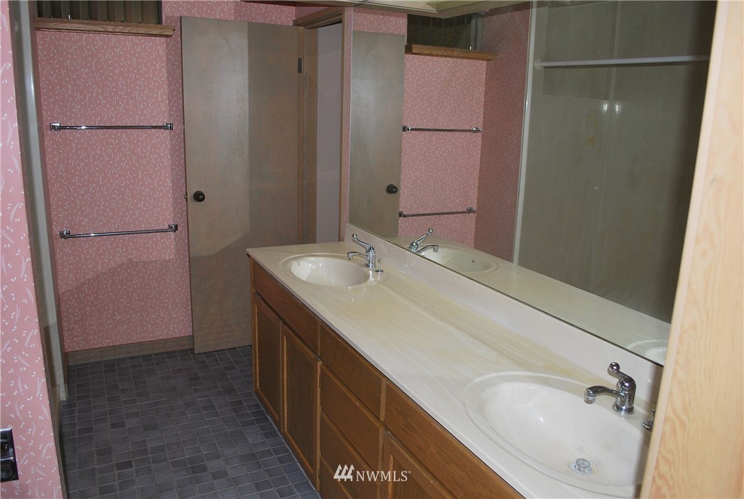 2021 1st Avenue, Unit 55 Seattle, WA 98121 - Photo 6 of 20 a bathroom with a granite countertop sink and a mirror