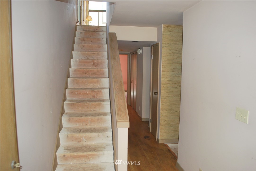 2021 1st Avenue, Unit 55 Seattle, WA 98121 - Photo 9 of 20 a view of staircase with white walls and windows