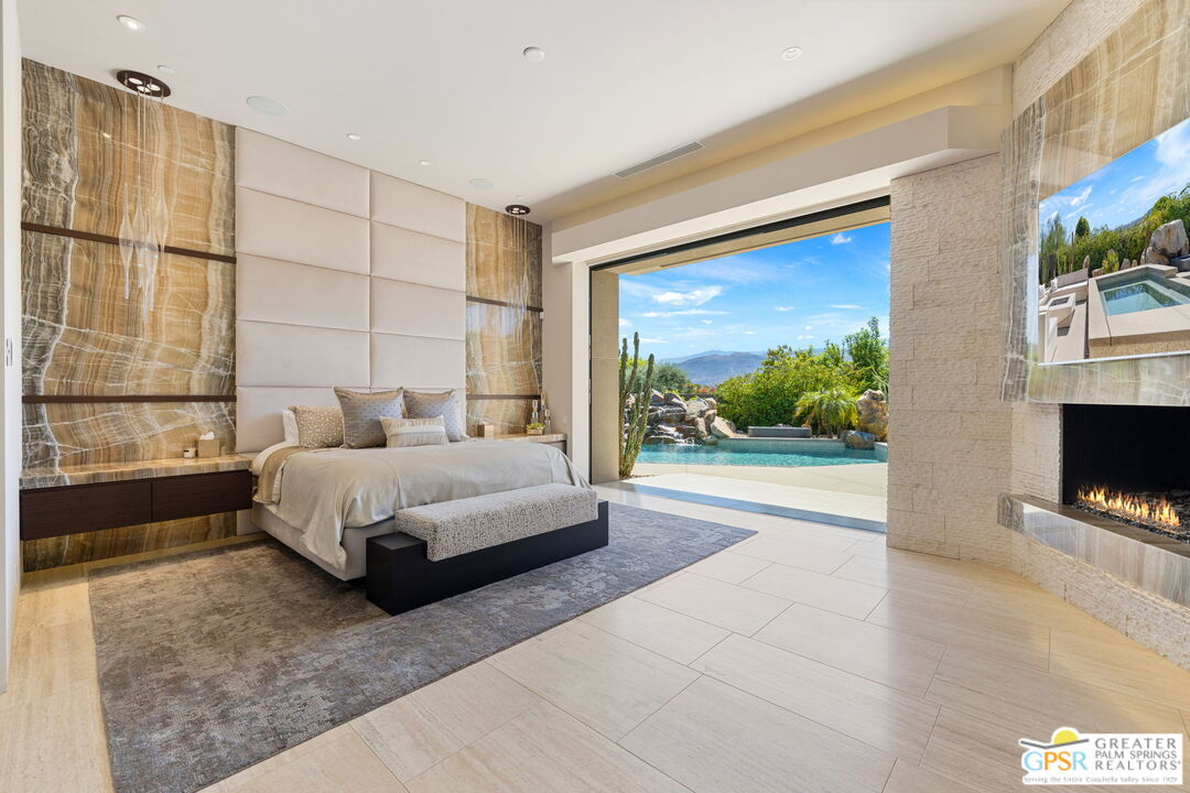 1 Sterling Ridge Drive Rancho Mirage, CA 92270 - Photo 31 of 51 a bedroom with a bed and a fireplace