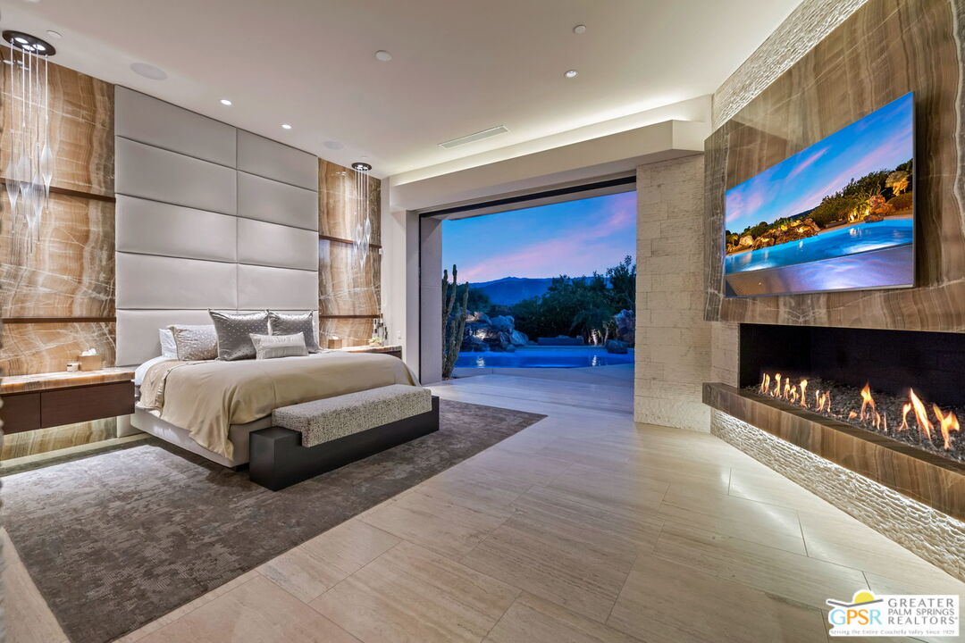 1 Sterling Ridge Drive Rancho Mirage, CA 92270 - Photo 36 of 51 a bedroom with a bed and a fireplace