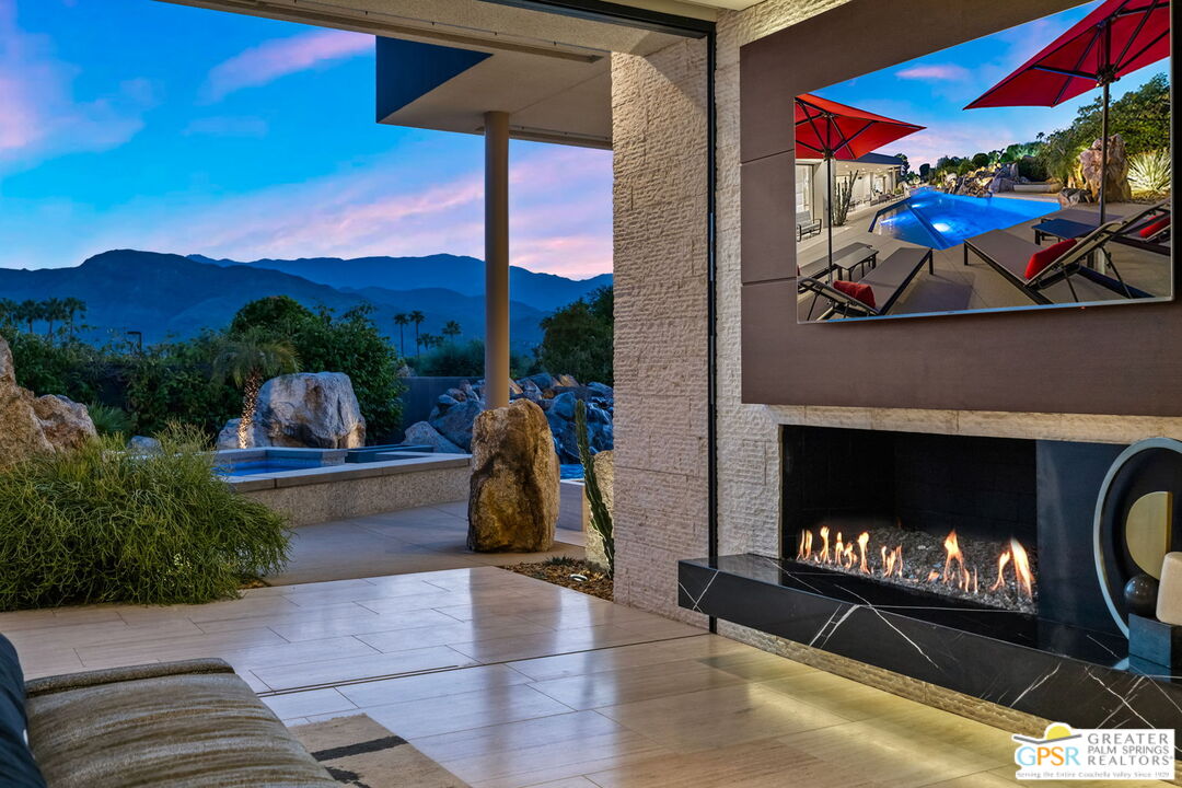 1 Sterling Ridge Drive Rancho Mirage, CA 92270 - Photo 37 of 51 a living room with furniture a fireplace and a flat screen tv