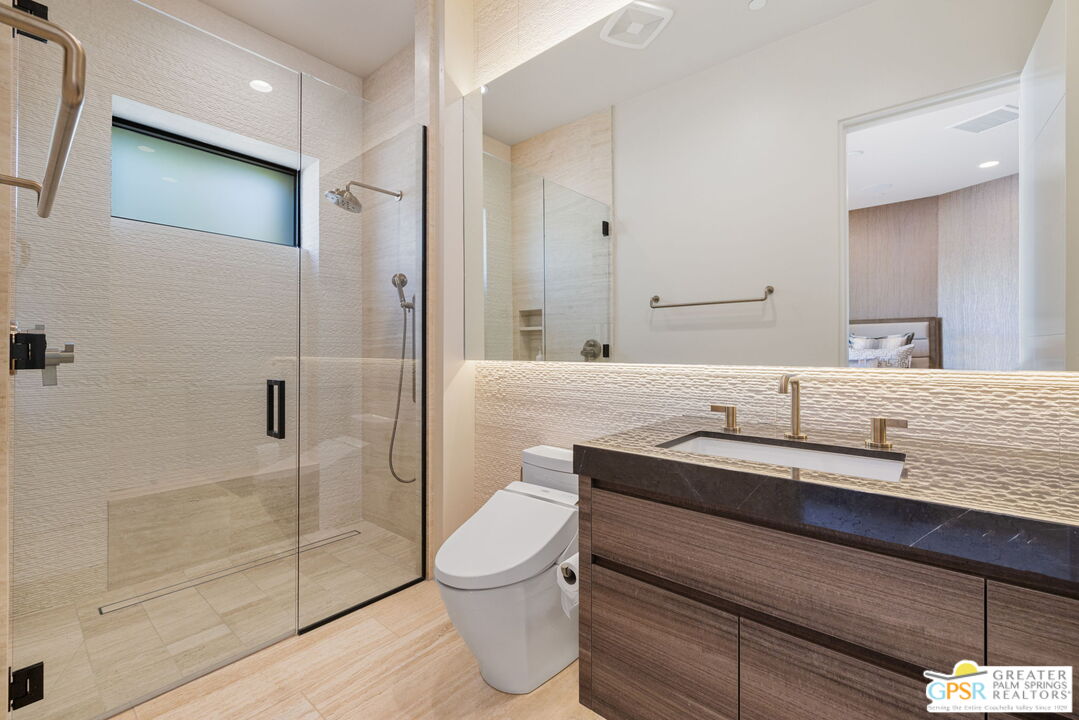 1 Sterling Ridge Drive Rancho Mirage, CA 92270 - Photo 47 of 51 a bathroom with a granite countertop sink a toilet and shower