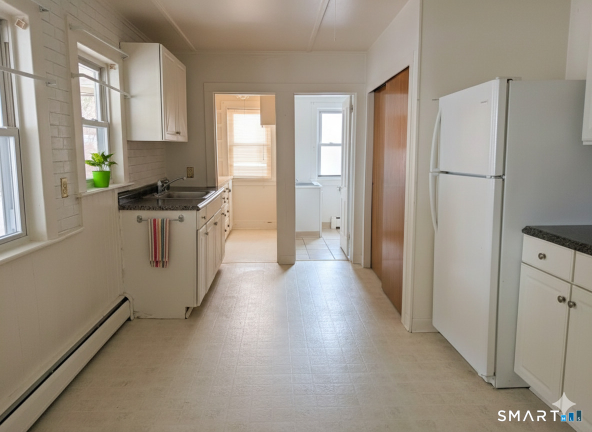 71 Bridge Street Canton, CT 06019 - Photo 3 of 6 a kitchen with stainless steel appliances a refrigerator a stove a sink and a window