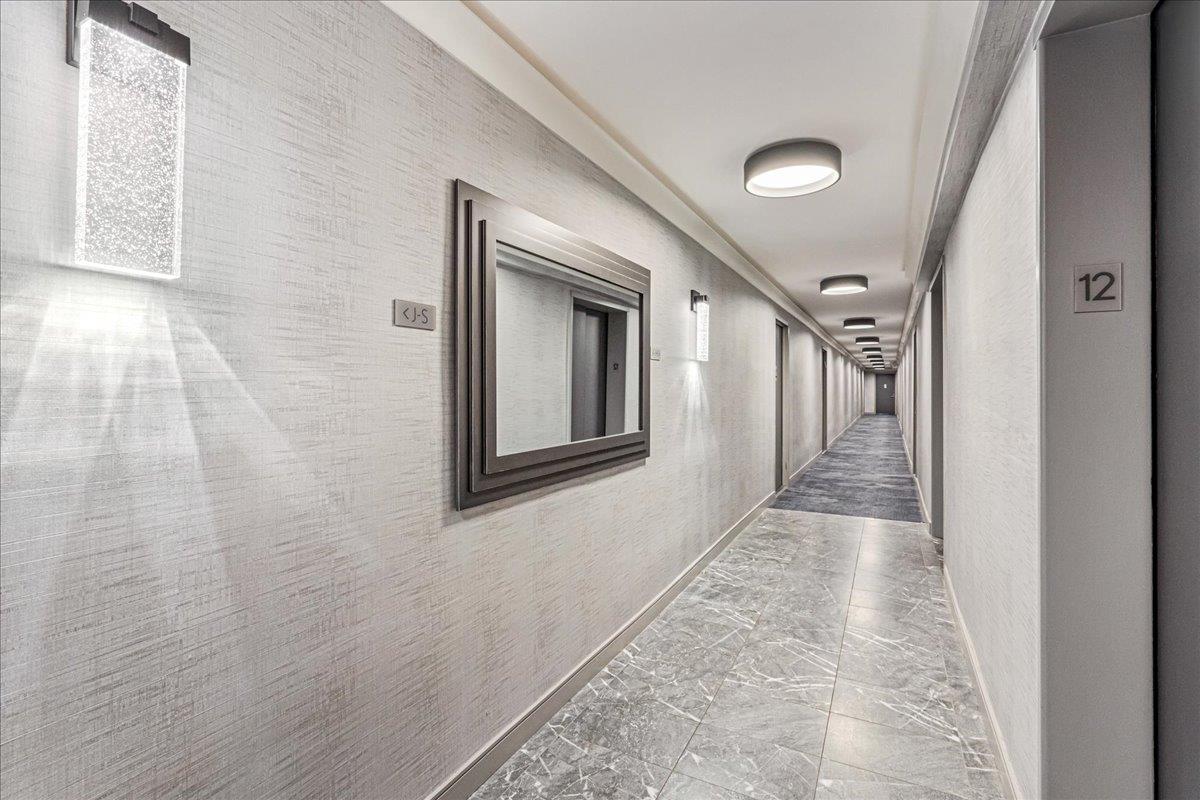 17-85 215th Street, Unit 12S Queens, NY 11360 - Photo 20 of 37 Hallway featuring baseboards and marble look tiles