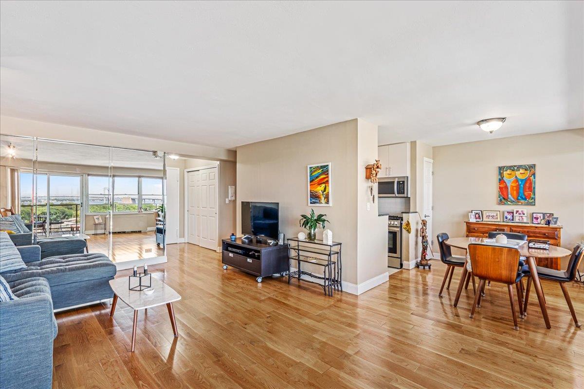 17-85 215th Street, Unit 12S Queens, NY 11360 - Photo 7 of 37 Living room featuring light wood-style flooring and baseboards