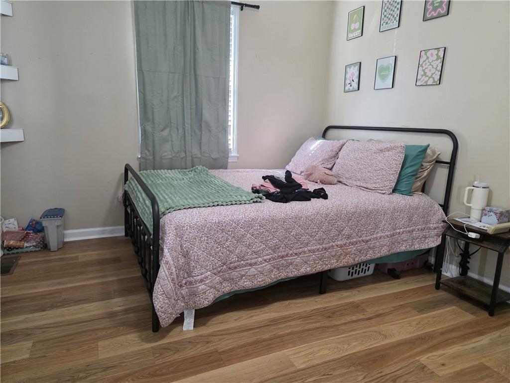 176 Runyon Loop Cedartown, GA 30125 - Photo 11 of 20 a bedroom with a bed and wooden floor