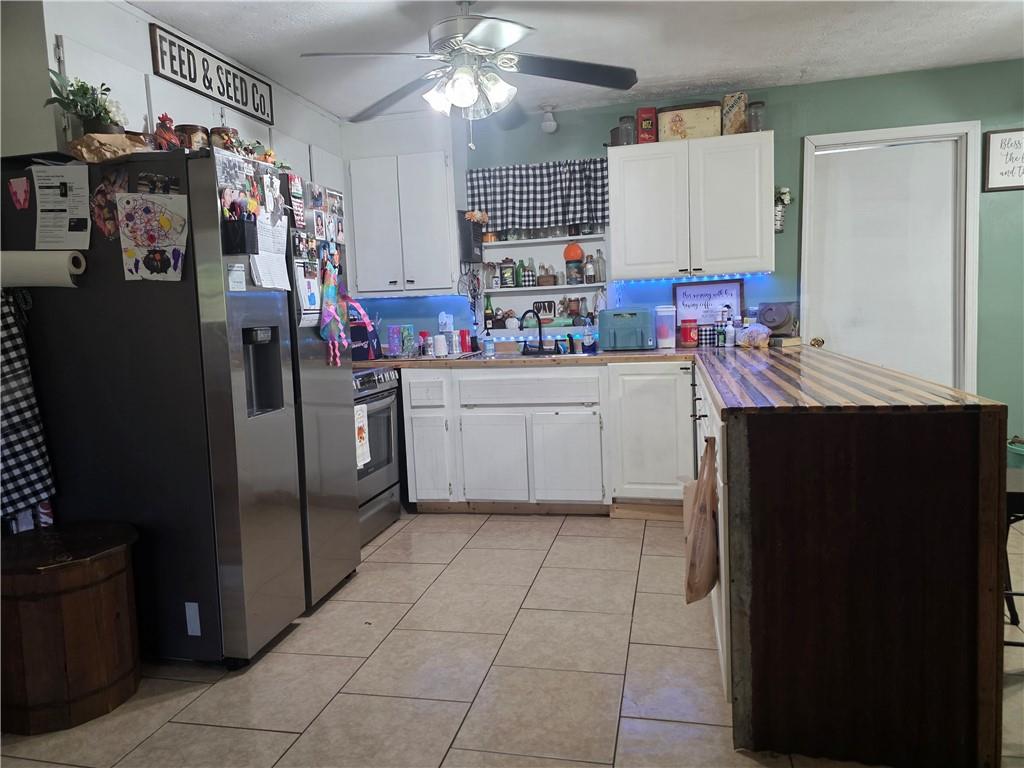 176 Runyon Loop Cedartown, GA 30125 - Photo 6 of 20 a kitchen with refrigerator and cabinets