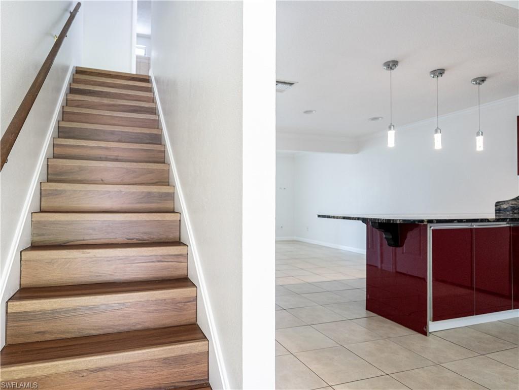 11001 Southeast Sunset Harbor Road, Unit 34 Summerfield, FL 34491 - Photo 16 of 31 Staircase featuring crown molding and light tile floors