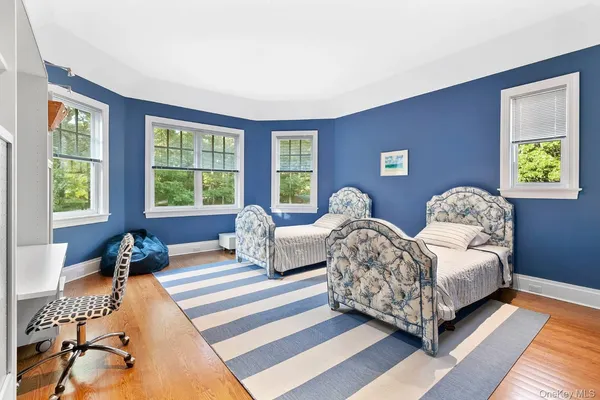 a spacious bedroom with two beds and a couch