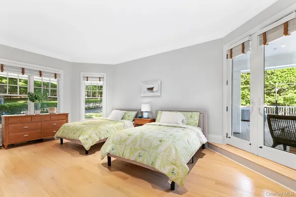 a bedroom with a bed and large windows
