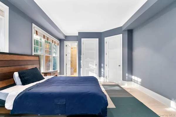 a bedroom with a large bed and a large window