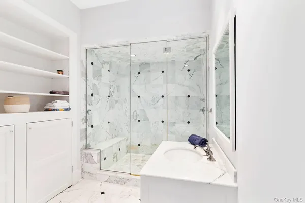a bathroom with a bathtub sink and mirror