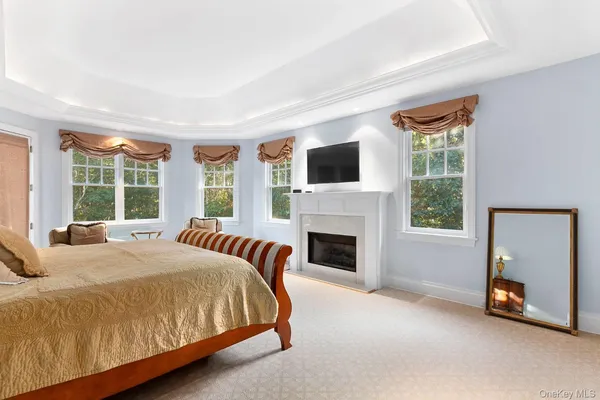 a spacious bedroom with a large bed and a fireplace