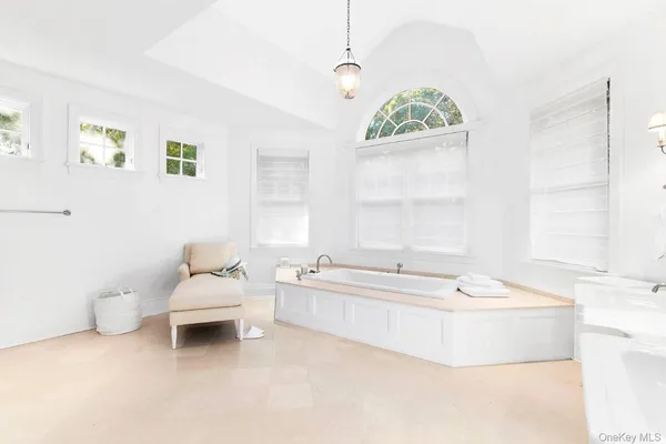 a spacious bathroom with a bathtub and window
