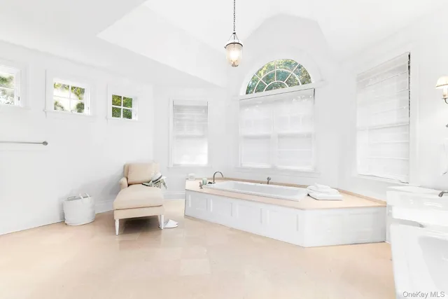 a spacious bathroom with a bathtub and window