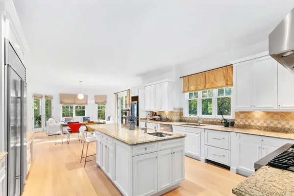 a open kitchen with stainless steel appliances kitchen island granite countertop a sink and cabinets