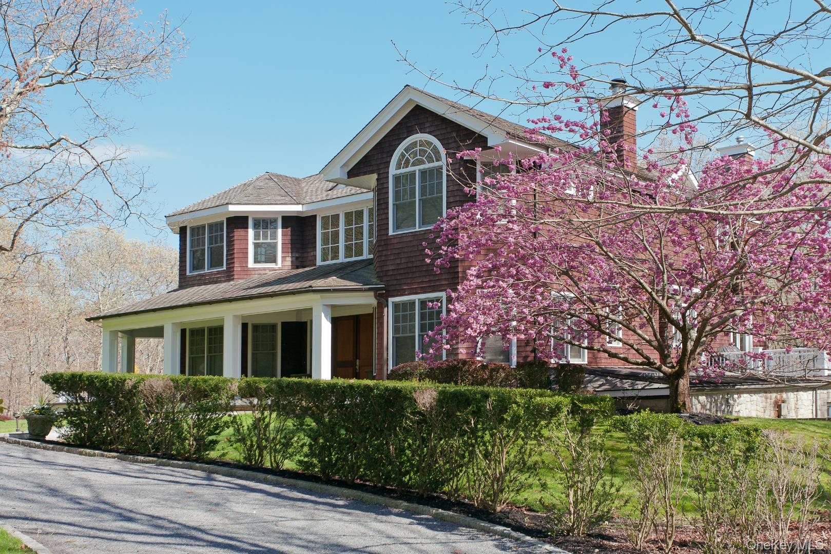 1477 Deerfield Road Water Mill, NY 11976 - Photo 5 of 17 a front view of a house with a garden