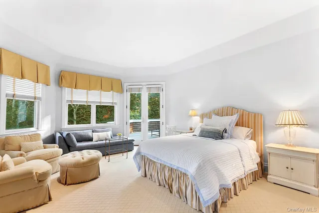 a bedroom with bed couch and window