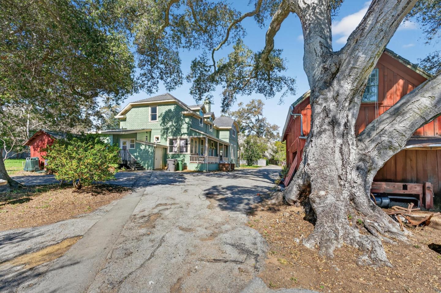3215 Woodside Road Woodside, CA 94062 - Photo 8 of 24 a view of a large house with a tree in the background