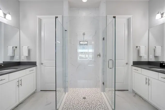 a bathroom with a bathtub shower sink and mirror