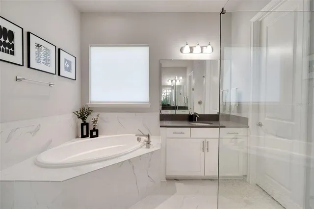 a bathroom with a granite countertop mirror and a shower