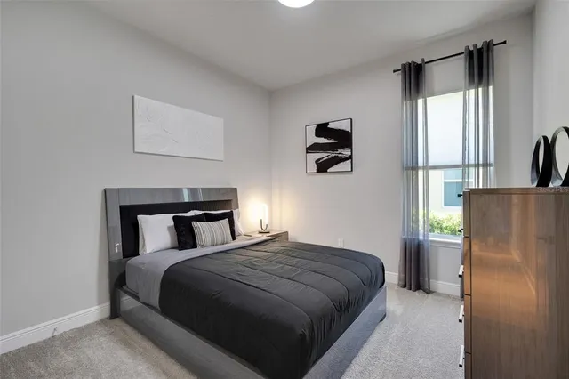 a view of an empty room with lots of white furniture