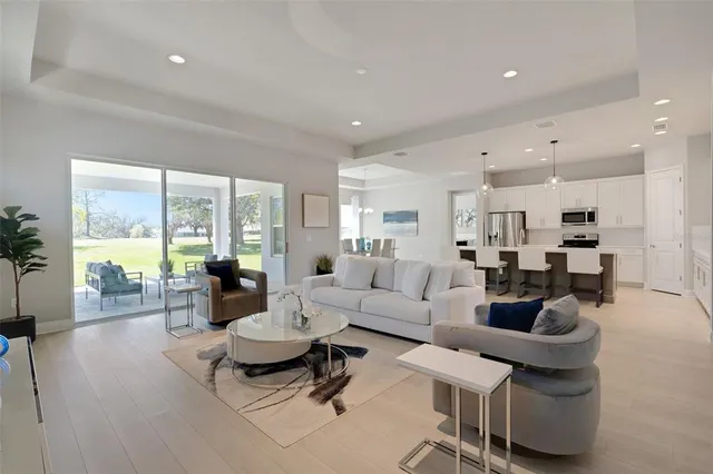 a living room with furniture and a chandelier