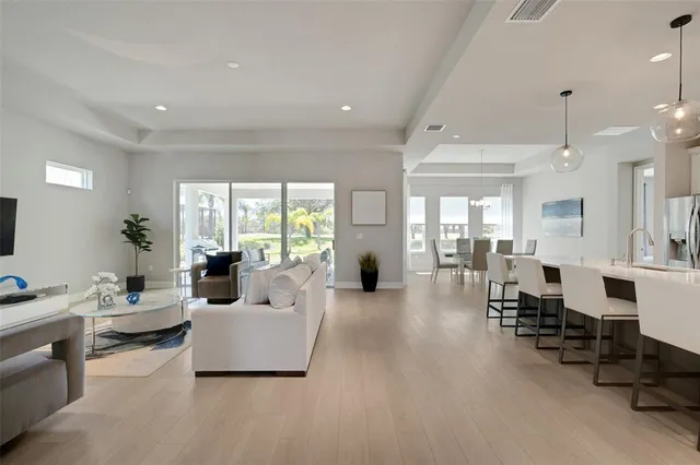 a kitchen with kitchen island granite countertop a table and chairs in it