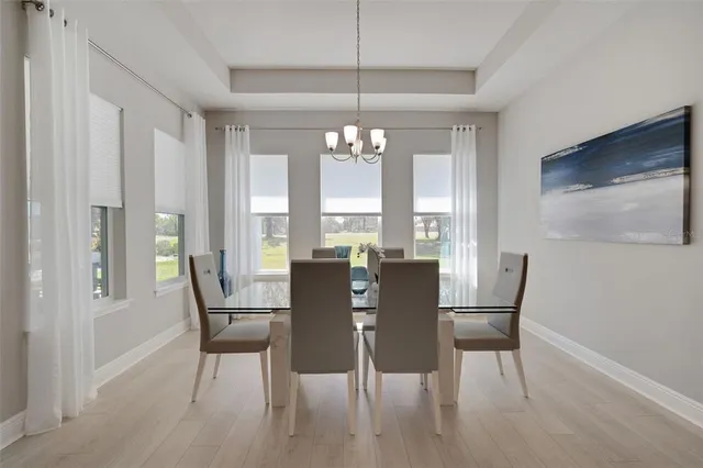 a spacious bedroom with a bed and a chandelier