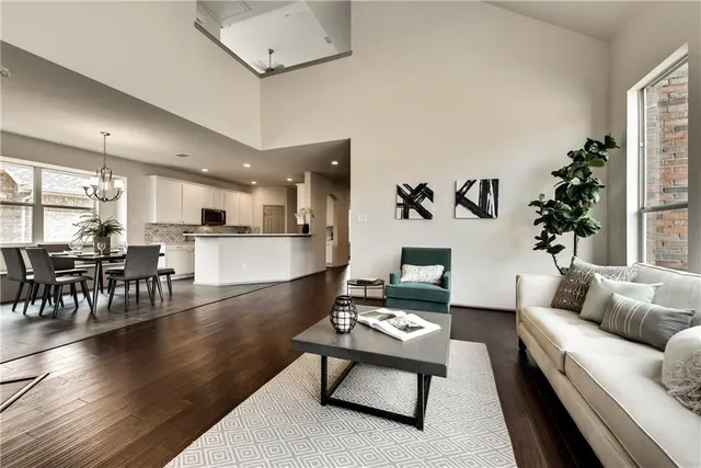 a living room with furniture and view of kitchen