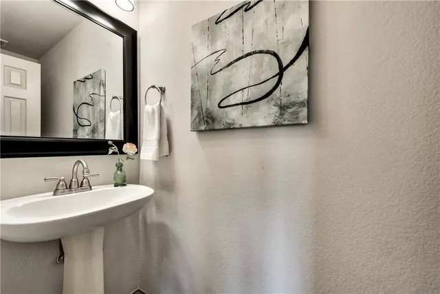 a bathroom with a sink and mirror