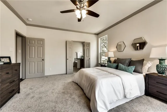 a bedroom with a large bed and a chandelier