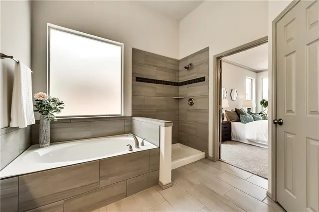a bathroom with a tub and shower