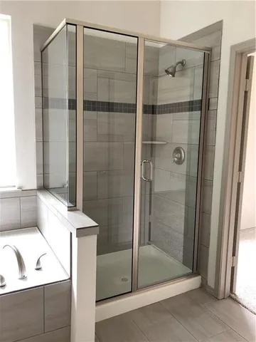 a bathroom with a tub and a shower