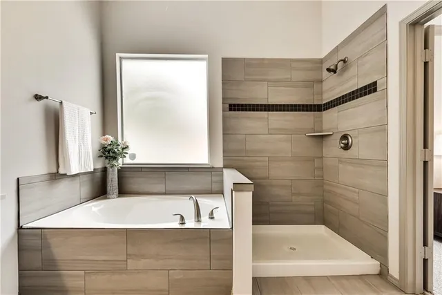 a bathroom with a bathtub and a shower