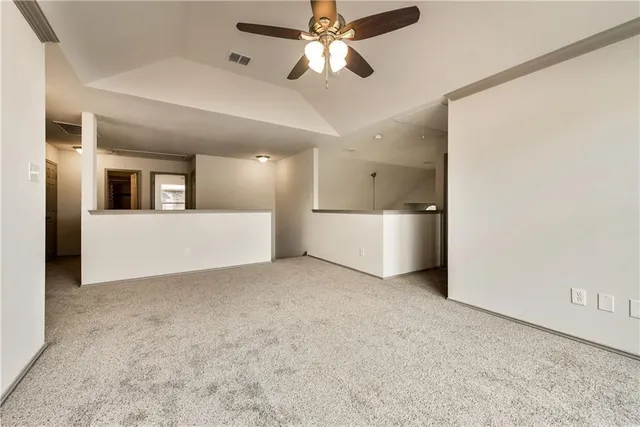 a view of a big room with closet and a ceiling fan