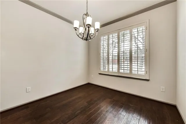 a view of a room with wooden floor and large window