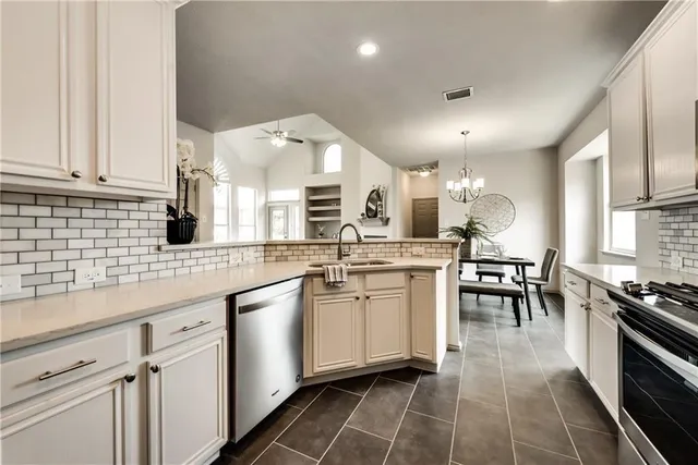 a kitchen with stainless steel appliances kitchen island granite countertop a sink and cabinets