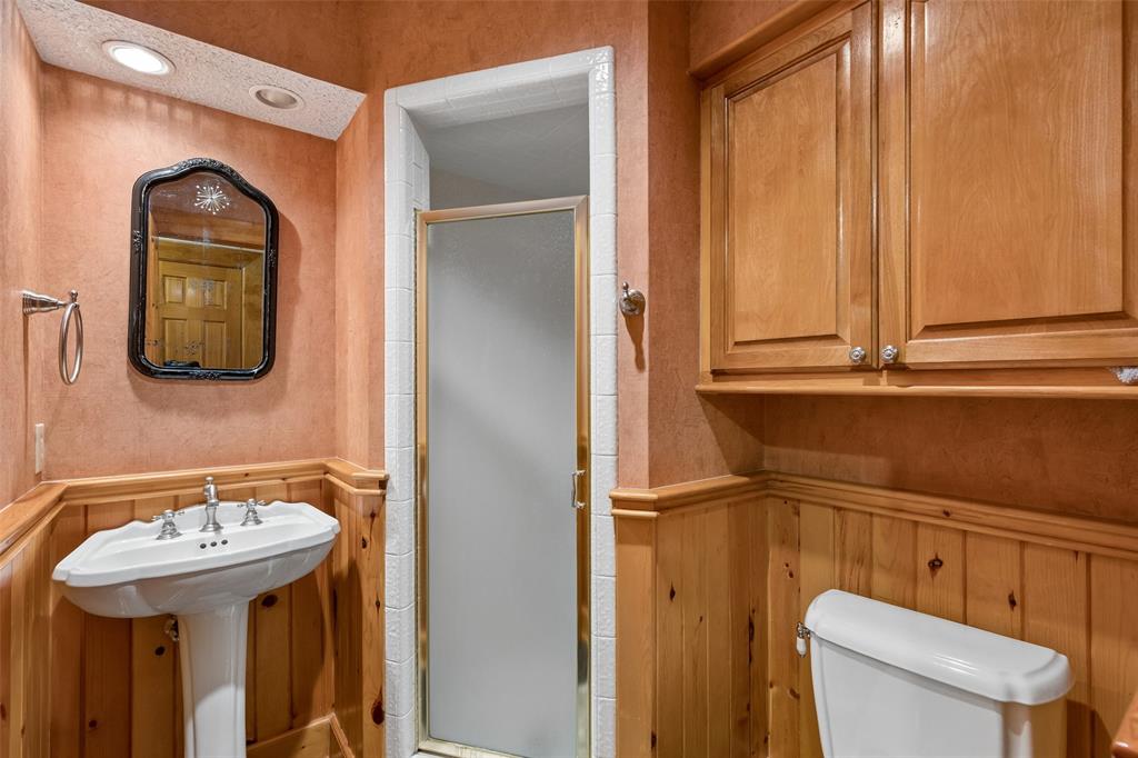 4 Eastshore Road Heath, TX 75032 - Photo 22 of 37 a bathroom with a sink a toilet and mirror