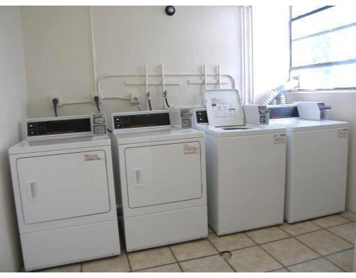 2501 Riverside Drive, Unit 218 Coral Springs, FL 33065 - Photo 15 of 15 a view of washer and dryer with bathroom in the background