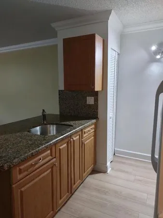 a kitchen with stainless steel appliances granite countertop a refrigerator and a sink
