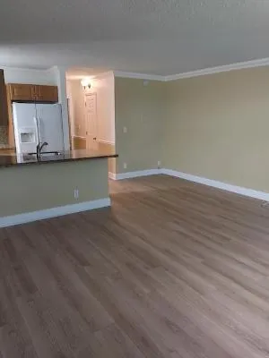 a view of room with wooden floor and cabinet